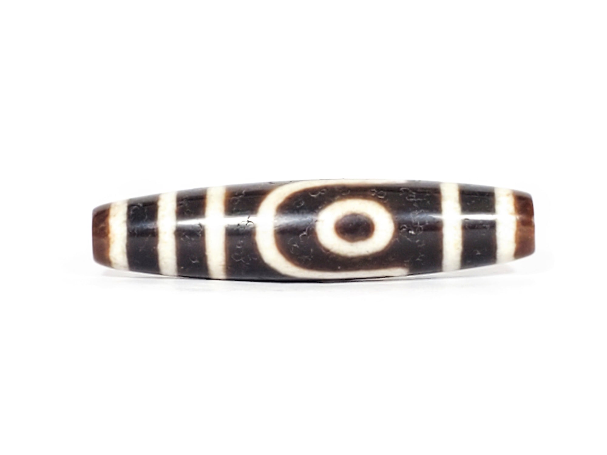 A vintage Dzi bead with a captivating Two Eye Motif. This authentic artifact exudes timeless charm and represents the intricate craftsmanship of ancient Dzi beads