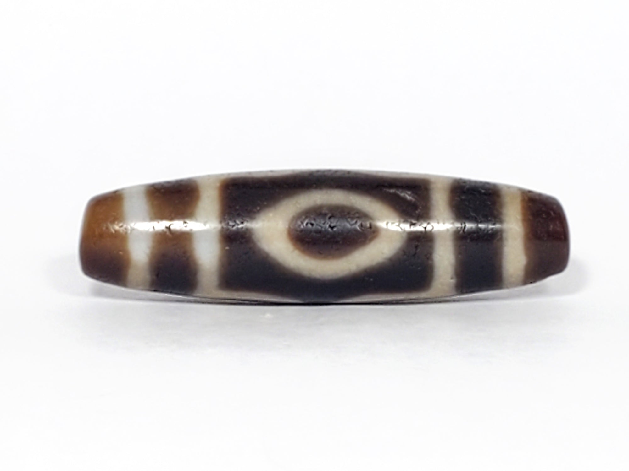 Real Tibetan dzi bead with three eye motif.  This dzi bead is extremely old.  It is a powerful dzi bead with a lot of dzi energy.