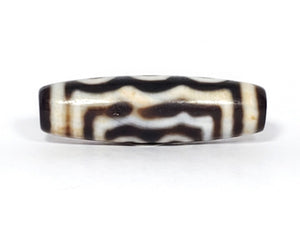 A vintage Dzi bead showcasing a beautiful Five Eye motif. The five intricately carved eyes represent wisdom, clarity, and spiritual insight. This rare and exquisite bead is a treasured piece for collectors and spiritual enthusiasts