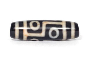 A vintage Dzi bead featuring a captivating Six Eye Motif. This authentic artifact, identified as TaD-V-S-SiE-051423, showcases the intricate patterns and spiritual significance of ancient Dzi beads