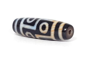 A vintage Dzi bead featuring a captivating Six Eye Motif. This authentic artifact, identified as TaD-V-S-SiE-051423, showcases the intricate patterns and spiritual significance of ancient Dzi beads