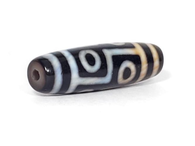 A vintage Dzi bead featuring a captivating Six Eye Motif. This authentic artifact, identified as TaD-V-S-SiE-051423, showcases the intricate patterns and spiritual significance of ancient Dzi beads