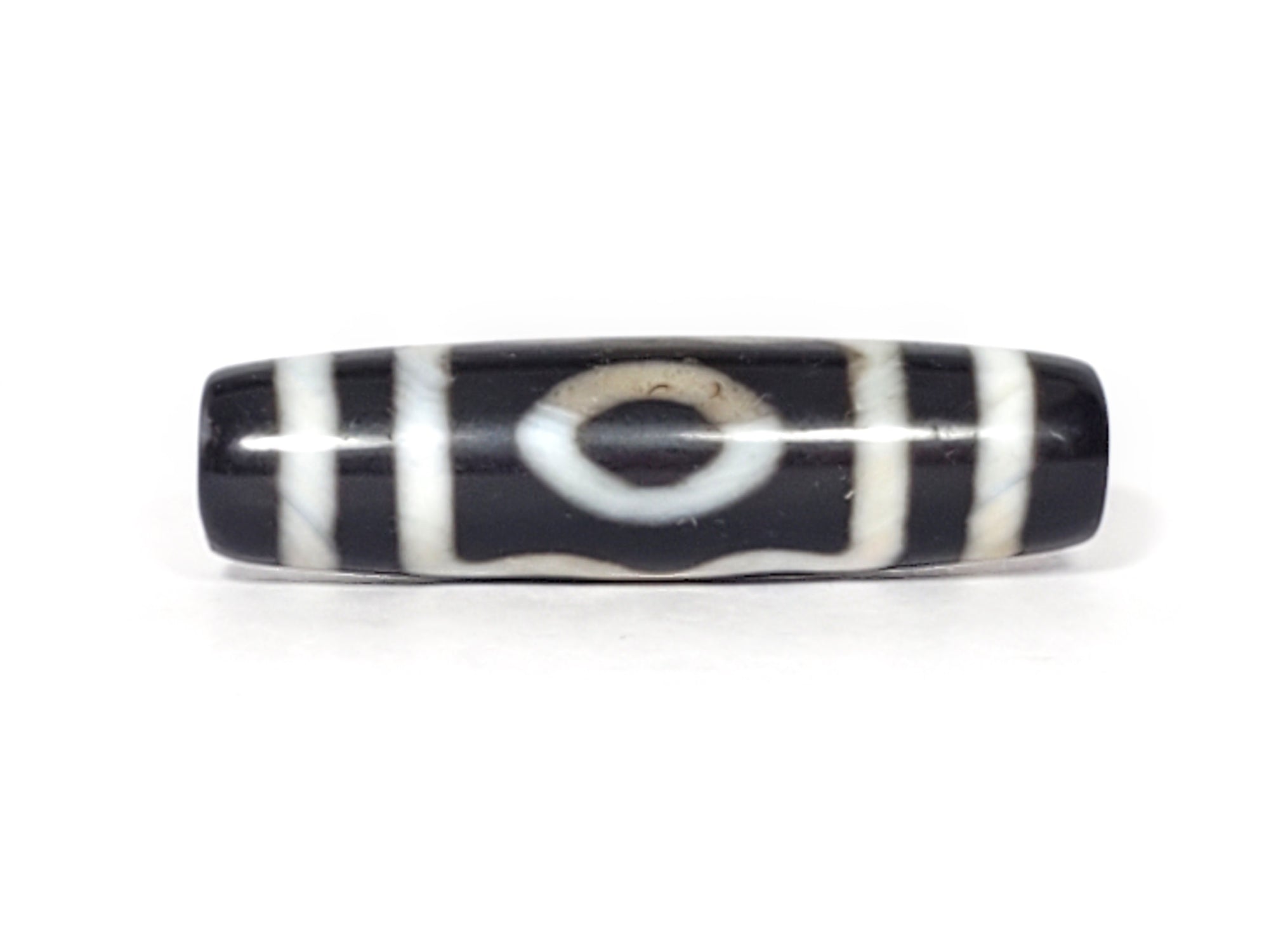 "A vintage Dzi bead featuring a captivating Three Eye Motif. This authentic artifact, identified as TD-ThE-001, showcases the intricate patterns and spiritual significance of ancient Dzi beads