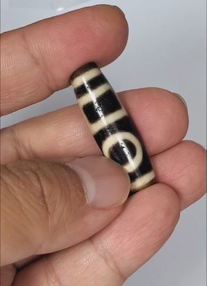 Genuine ancient Dzi bead featuring a captivating Double Heaven & Earth motif. This extremely old bead holds historical significance and carries a sense of divine connection.