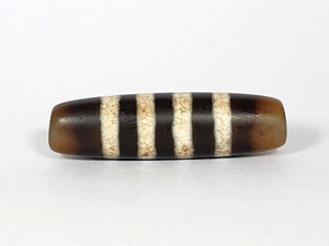 Seven Stripe Chung Dzi" Description: "Authentic Seven Stripe Chung Dzi bead, showcasing its distinctive seven stripe pattern. This ancient artifact carries deep cultural and historical significance