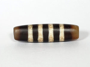 Seven Stripe Chung Dzi" Description: "Authentic Seven Stripe Chung Dzi bead, showcasing its distinctive seven stripe pattern. This ancient artifact carries deep cultural and historical significance