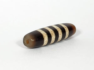 Seven Stripe Chung Dzi" Description: "Authentic Seven Stripe Chung Dzi bead, showcasing its distinctive seven stripe pattern. This ancient artifact carries deep cultural and historical significance