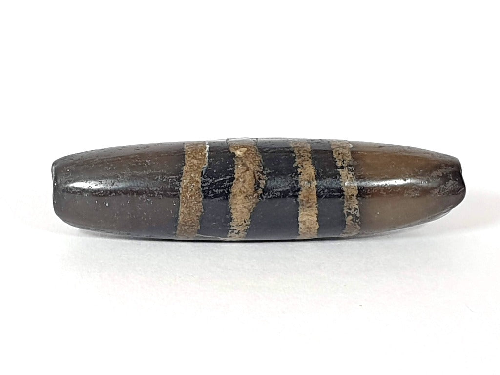 Rare Ancient Seven Stripe Chung Dzi" Description: "Authentic and rare ancient Seven Stripe Chung Dzi bead, a treasured artifact from the past. This bead holds immense historical significance and is extremely old."