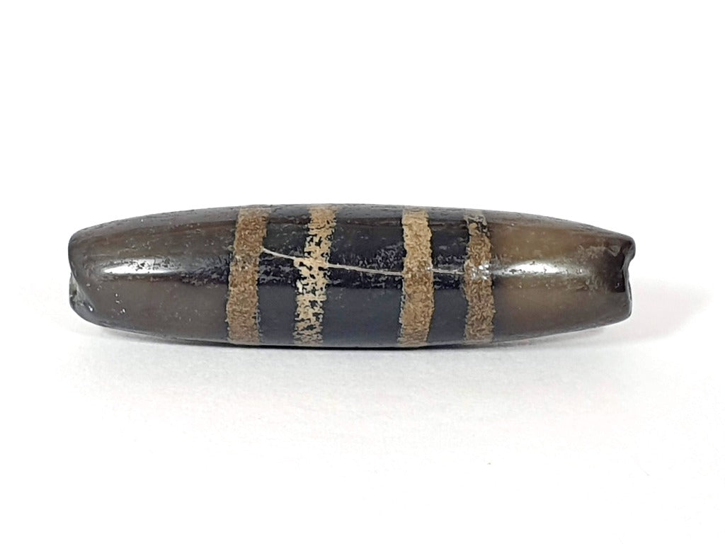 Rare Ancient Seven Stripe Chung Dzi" Description: "Authentic and rare ancient Seven Stripe Chung Dzi bead, a treasured artifact from the past. This bead holds immense historical significance and is extremely old."