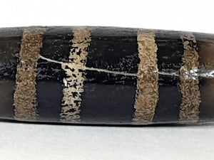 Rare Ancient Seven Stripe Chung Dzi" Description: "Authentic and rare ancient Seven Stripe Chung Dzi bead, a treasured artifact from the past. This bead holds immense historical significance and is extremely old."