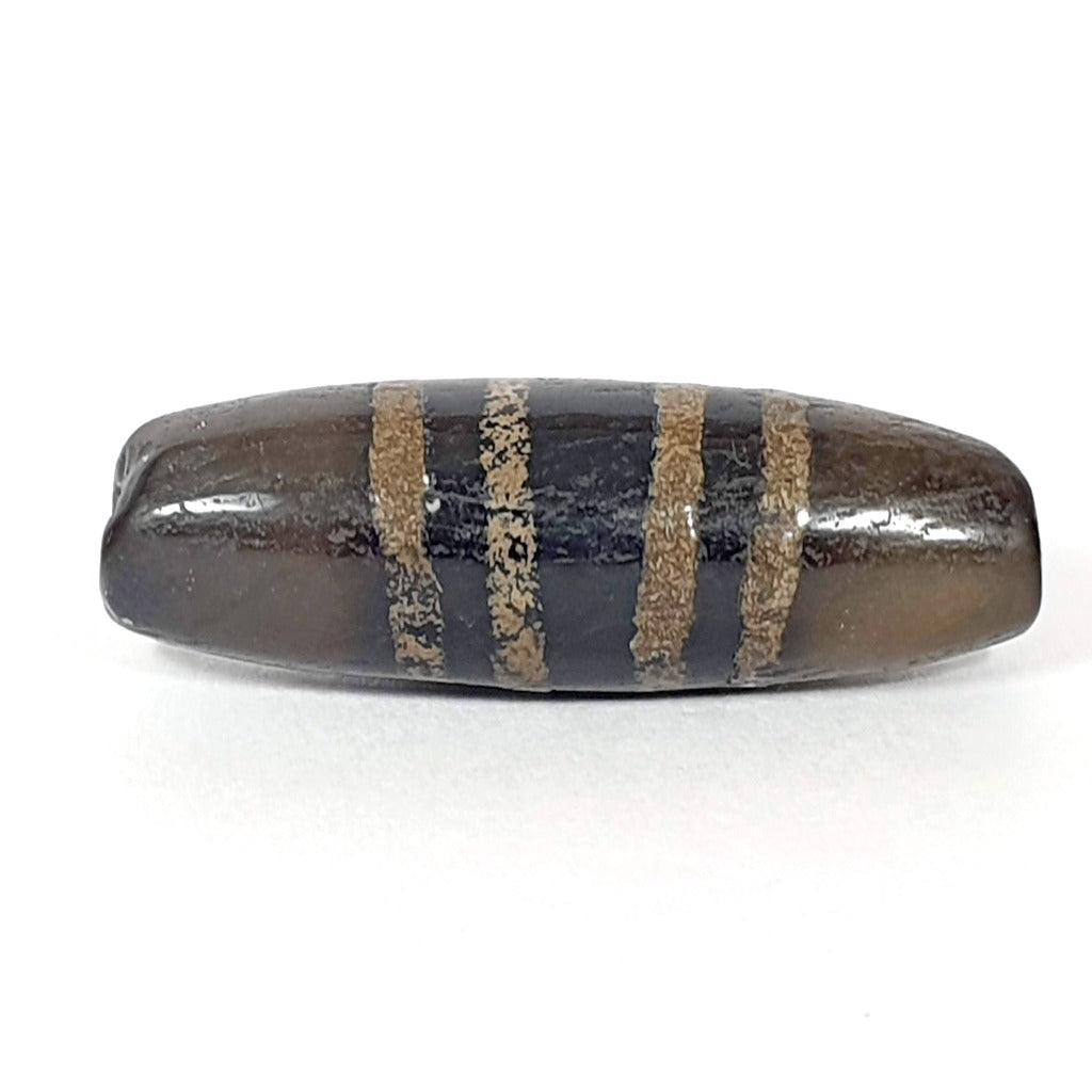 Rare Ancient Seven Stripe Chung Dzi" Description: "Authentic and rare ancient Seven Stripe Chung Dzi bead, a treasured artifact from the past. This bead holds immense historical significance and is extremely old."