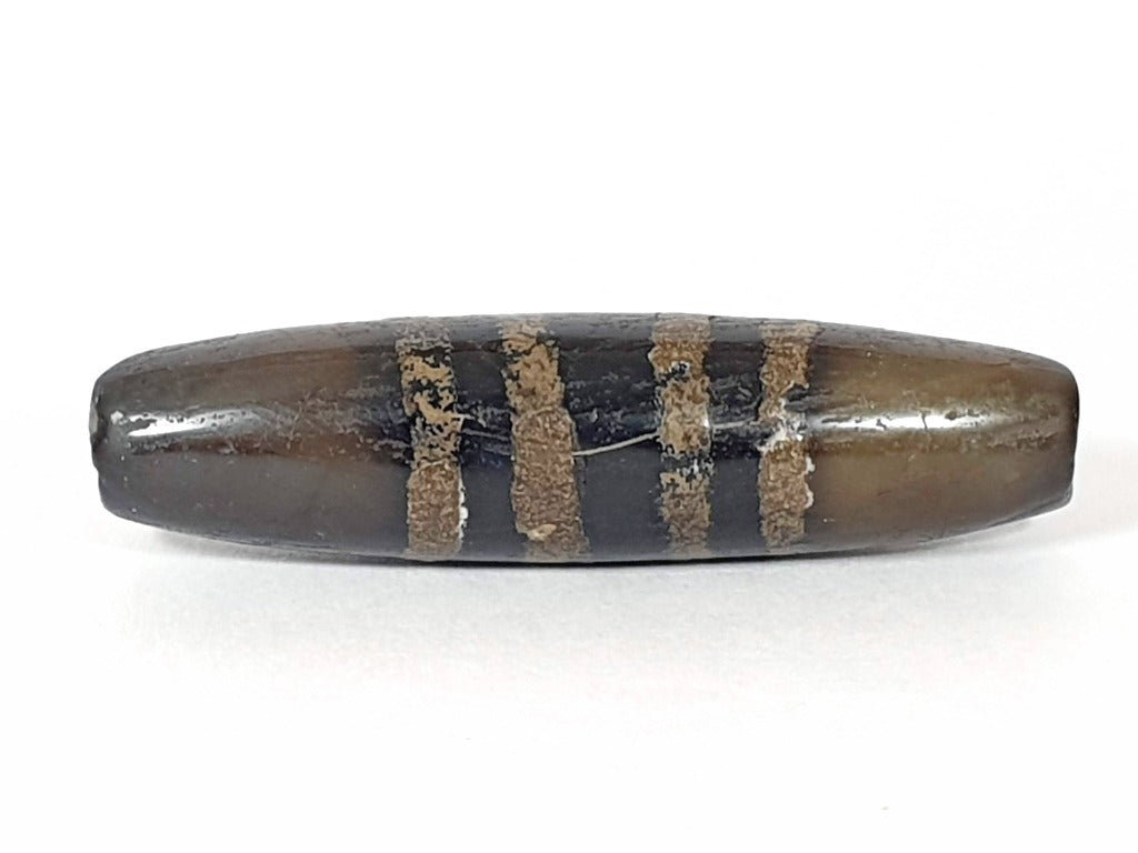 Rare Ancient Seven Stripe Chung Dzi" Description: "Authentic and rare ancient Seven Stripe Chung Dzi bead, a treasured artifact from the past. This bead holds immense historical significance and is extremely old."