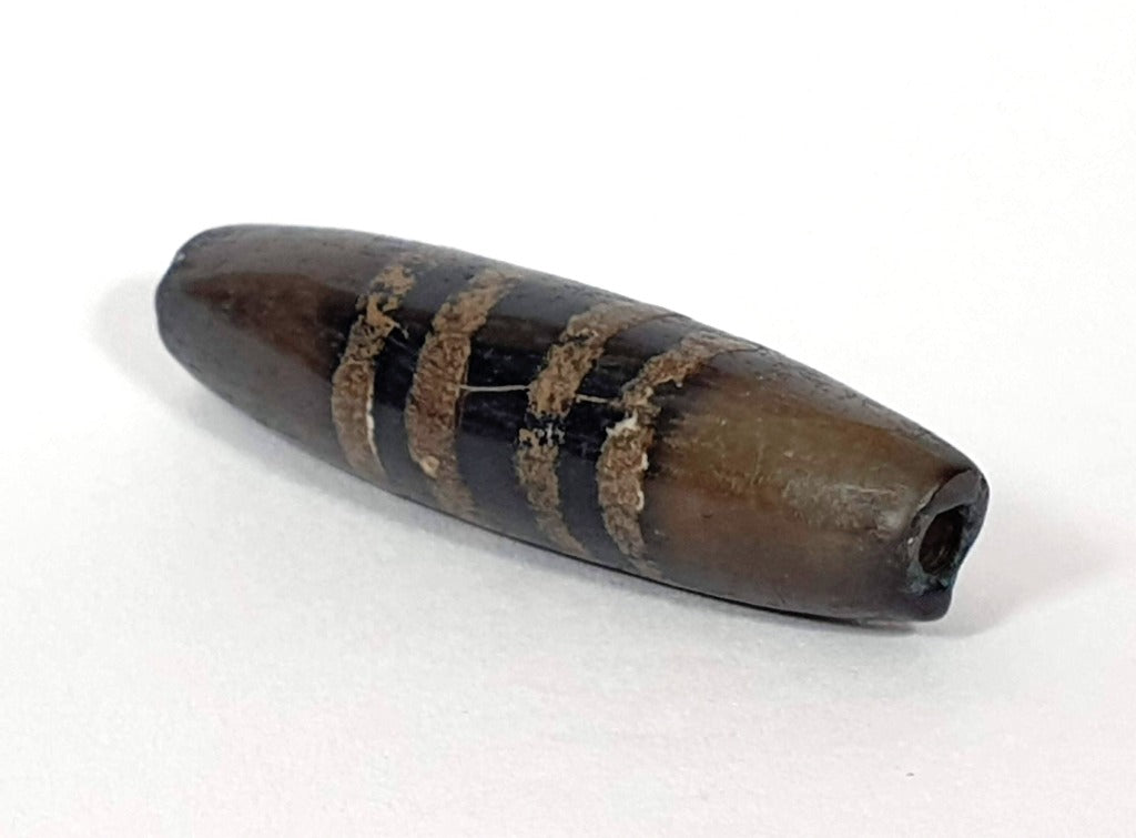 Rare Ancient Seven Stripe Chung Dzi" Description: "Authentic and rare ancient Seven Stripe Chung Dzi bead, a treasured artifact from the past. This bead holds immense historical significance and is extremely old."