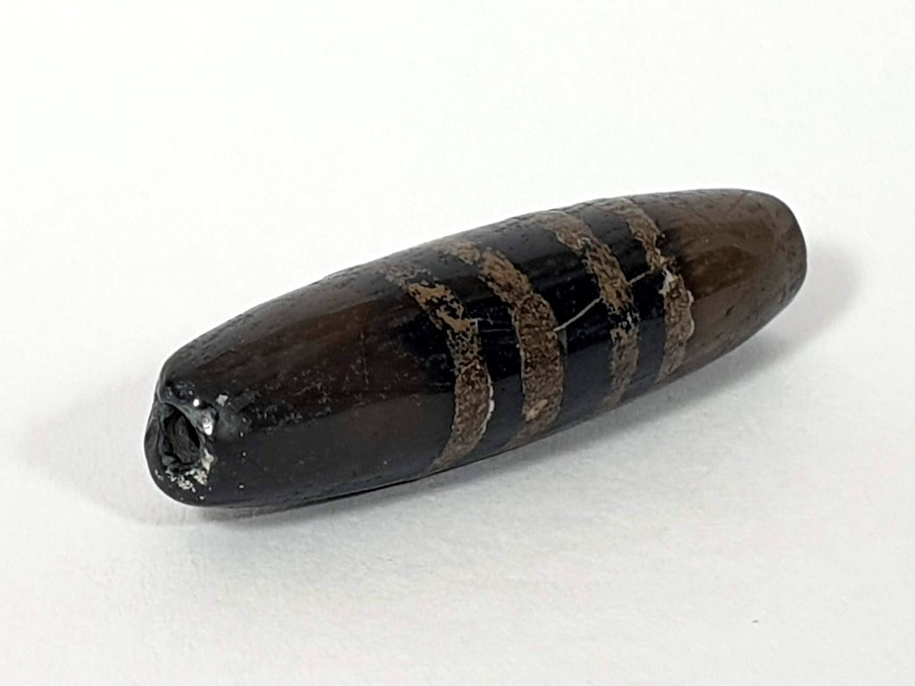 Rare Ancient Seven Stripe Chung Dzi" Description: "Authentic and rare ancient Seven Stripe Chung Dzi bead, a treasured artifact from the past. This bead holds immense historical significance and is extremely old."