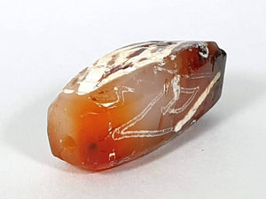  ancient Dzi bead made from Carnelian, showcasing a unique and highly sought-after Four Diamond Eye-In-Eye & Wave motif. This bead is exceptionally rare, adding to its collectability and value. The intricate design combines protective symbolism with the fluidity and power of waves, making it a remarkable piece of ancient craftsmanship and spiritual significance."