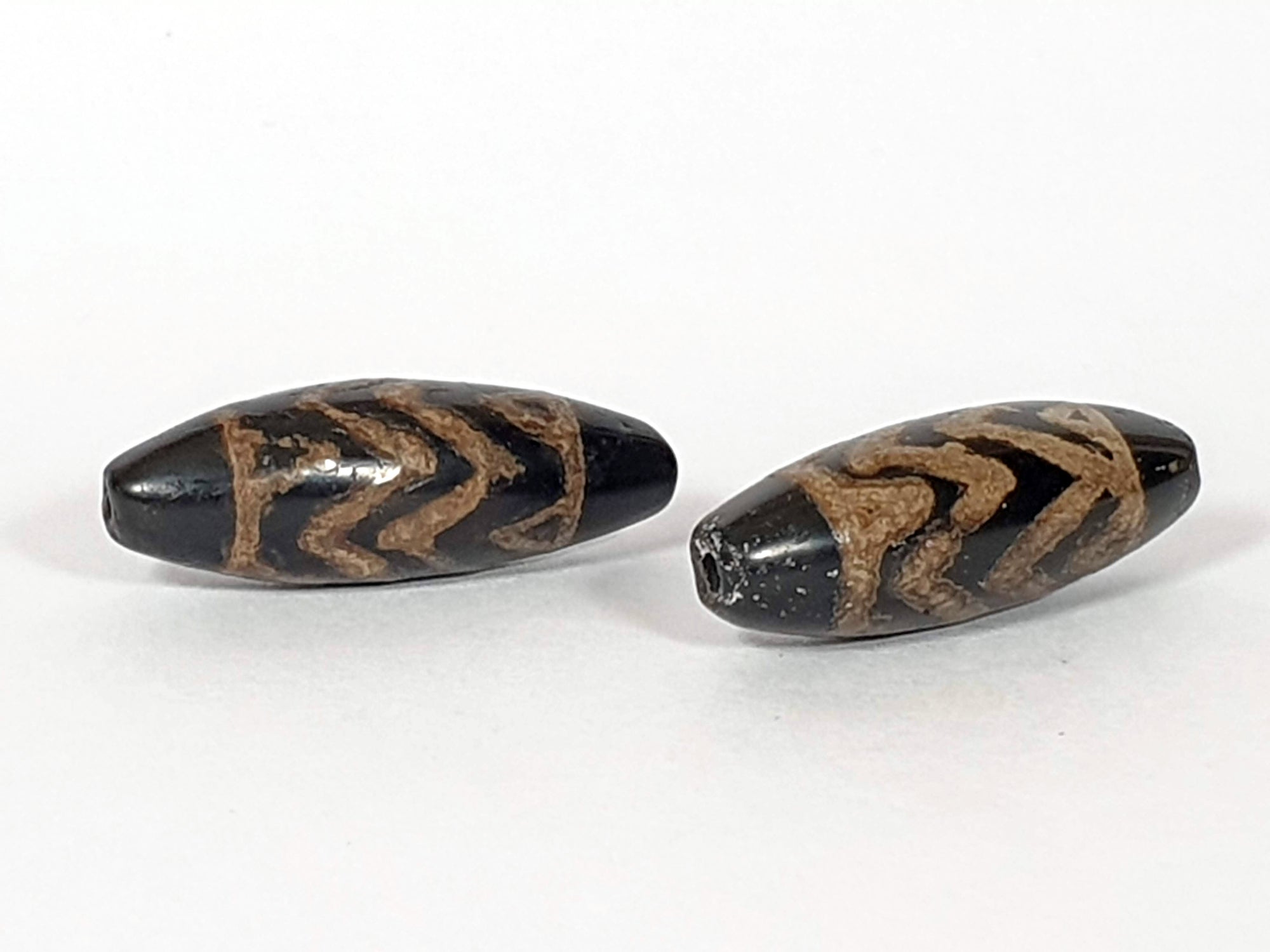 Pair of Antique Four Tiger Tooth Motif Dzi Beads