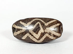 rare triangular shaped dzi bead.  antique dzi bead with three eye & tiger tooth motif