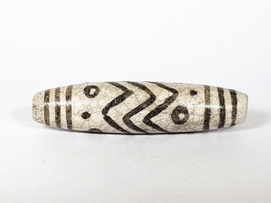 Vintage White Tiger Stripes, Eyes & Stars Dzi Bead" Description: "A vintage Dzi bead with a faux antique appearance featuring captivating white tiger stripes, mesmerizing eyes, and celestial stars motif