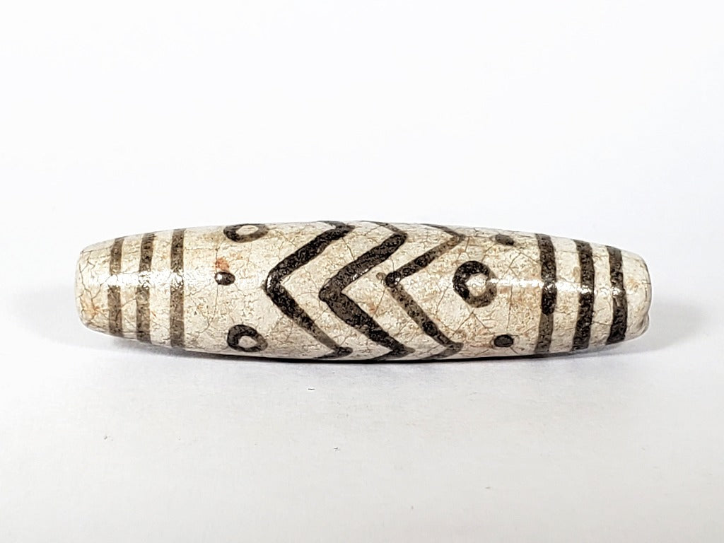 Vintage White Tiger Stripes, Eyes & Stars Dzi Bead" Description: "A vintage Dzi bead with a faux antique appearance featuring captivating white tiger stripes, mesmerizing eyes, and celestial stars motif