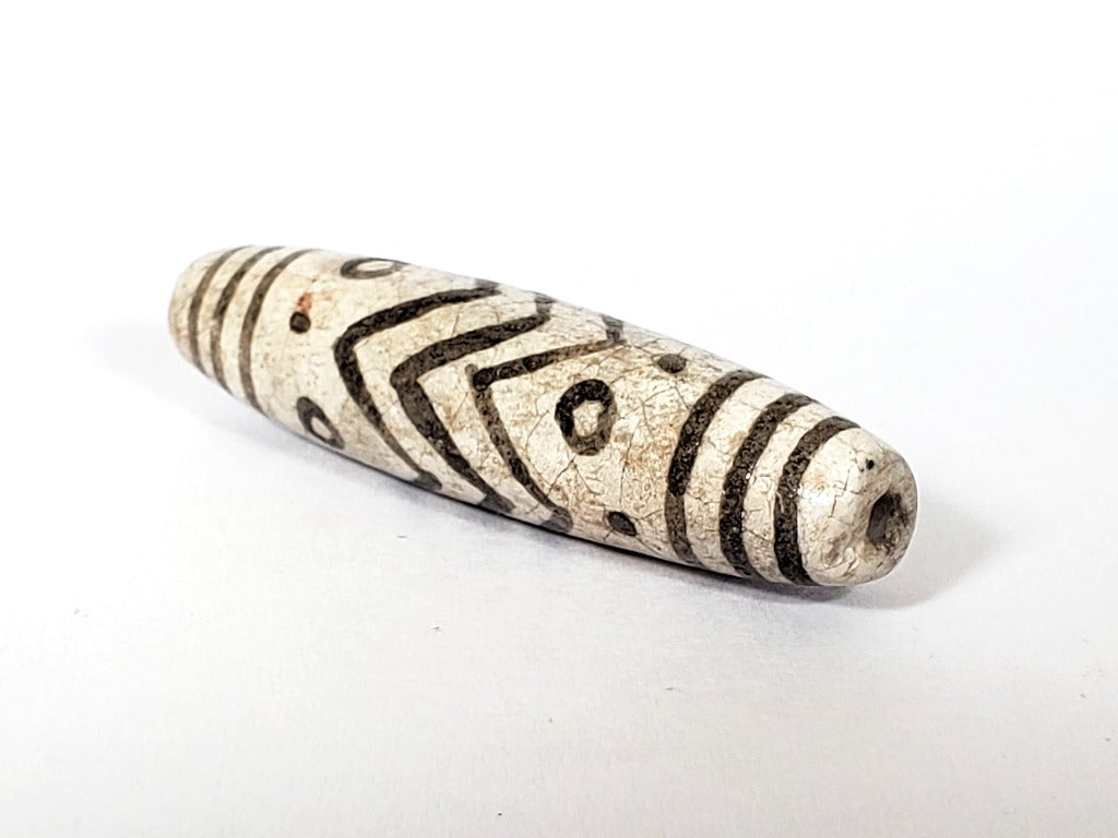 Vintage White Tiger Stripes, Eyes & Stars Dzi Bead" Description: "A vintage Dzi bead with a faux antique appearance featuring captivating white tiger stripes, mesmerizing eyes, and celestial stars motif