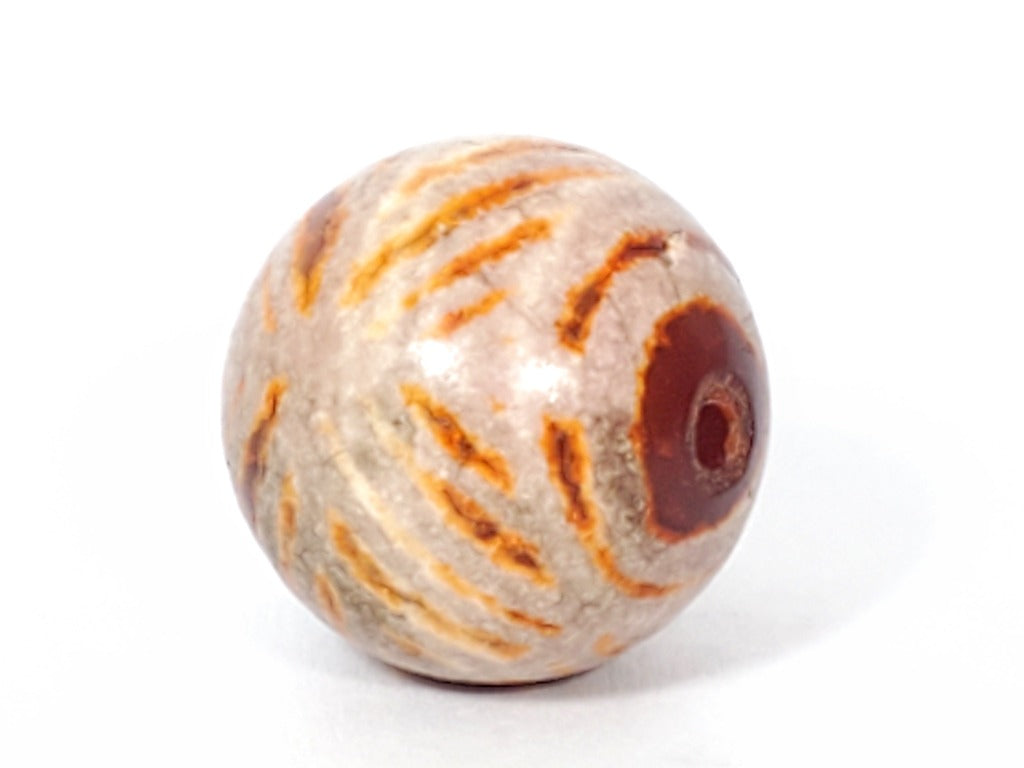 Ancient Round Double Diamond Eye-In-Eye Motif Carnelian Dzi Bead. An ancient round Dzi bead featuring a distinctive Double Diamond Eye-In-Eye motif. This Carnelian Dzi bead holds immense historical and cultural value, reflecting the meticulous craftsmanship of Tibetan artisans