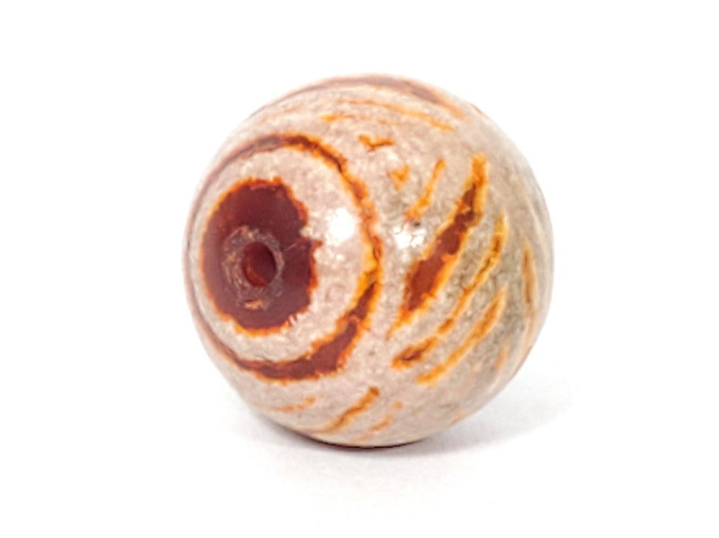 Ancient Round Double Diamond Eye-In-Eye Motif Carnelian Dzi Bead. An ancient round Dzi bead featuring a distinctive Double Diamond Eye-In-Eye motif. This Carnelian Dzi bead holds immense historical and cultural value, reflecting the meticulous craftsmanship of Tibetan artisans