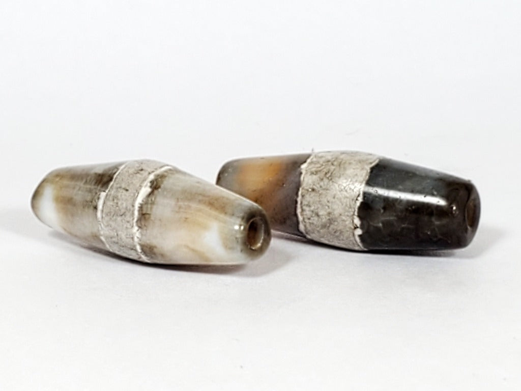 Pair of Ancient Single Stripe Dzi" Description: "Authentic pair of ancient Single Stripe Dzi beads, showcasing their timeless beauty. These remarkable artifacts hold historical and cultural significance