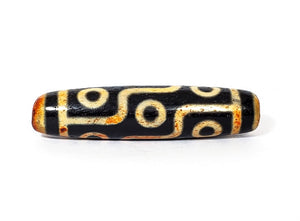 A vintage Dzi bead with a faux antique appearance featuring a captivating nine-eye motif. The bead exhibits intricate carvings and an aged texture, reminiscent of ancient artifacts with deep spiritual significance. The nine eyes symbolize protection, wisdom, and spiritual insight