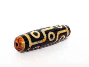 A vintage Dzi bead with a faux antique appearance featuring a captivating nine-eye motif. The bead exhibits intricate carvings and an aged texture, reminiscent of ancient artifacts with deep spiritual significance. The nine eyes symbolize protection, wisdom, and spiritual insight