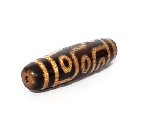 A vintage Dzi bead with a faux antique appearance featuring a mesmerizing nine-eye motif. The intricate carvings and weathered texture give it an ancient look, evoking a sense of spiritual power and wisdom. The nine eyes symbolize protection, insight, and spiritual enlightenment. 