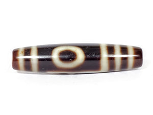 A vintage Dzi bead featuring a captivating One Eye & Mountain motif. This authentic artifact, identified as TD-OEM-1, showcases the intricate patterns and spiritual symbolism of ancient Dzi beads