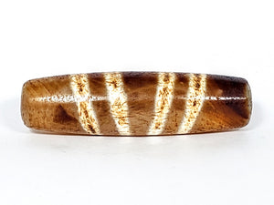  "Authentic and rare old Tibetan Seven Stripe Motif Dzi Bead, showcasing its unique design and cultural significance."