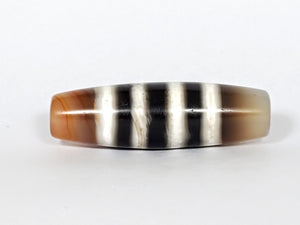 Vintage Seven Stripe Chung Dzi Bead" Description: "Authentic vintage Seven Stripe Chung Dzi bead showcasing its distinctive seven stripe pattern. This ancient bead carries a sense of history and cultural significance