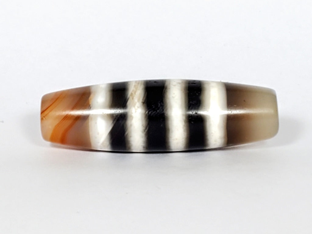 Vintage Seven Stripe Chung Dzi Bead" Description: "Authentic vintage Seven Stripe Chung Dzi bead showcasing its distinctive seven stripe pattern. This ancient bead carries a sense of history and cultural significance