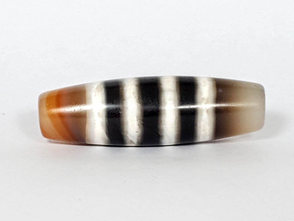 Vintage Seven Stripe Chung Dzi Bead" Description: "Authentic vintage Seven Stripe Chung Dzi bead showcasing its distinctive seven stripe pattern. This ancient bead carries a sense of history and cultural significance