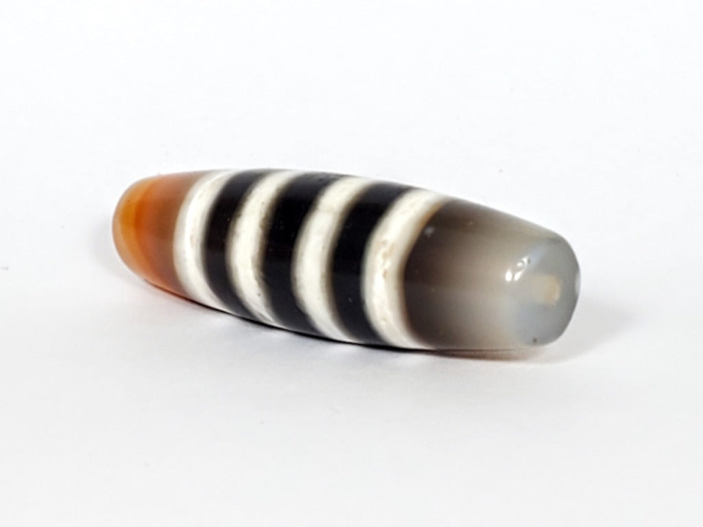 Vintage Seven Stripe Chung Dzi Bead" Description: "Authentic vintage Seven Stripe Chung Dzi bead showcasing its distinctive seven stripe pattern. This ancient bead carries a sense of history and cultural significance