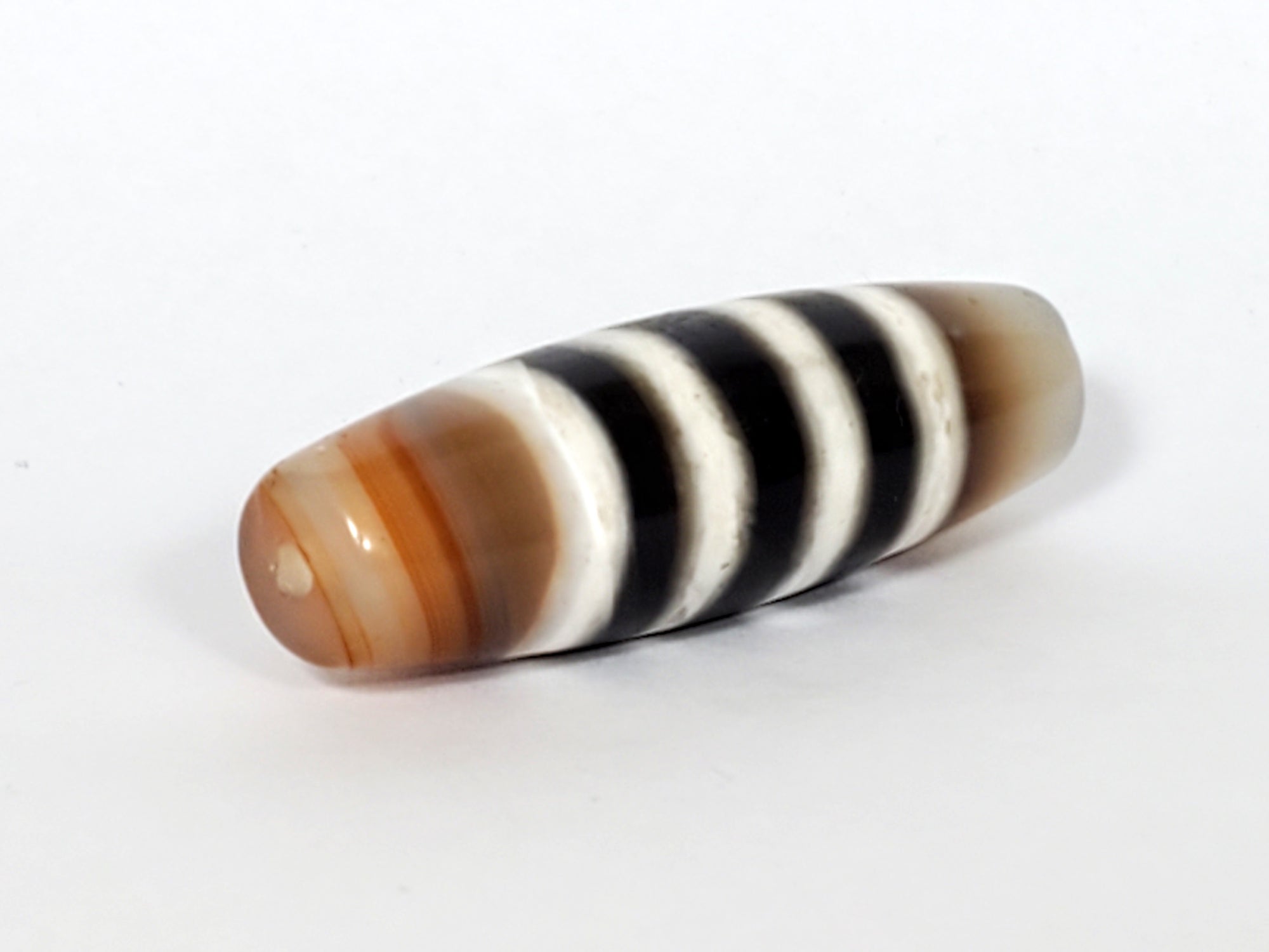 Vintage Seven Stripe Chung Dzi Bead" Description: "Authentic vintage Seven Stripe Chung Dzi bead showcasing its distinctive seven stripe pattern. This ancient bead carries a sense of history and cultural significance