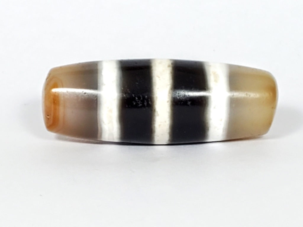 Authentic vintage Five Stripe Chung Dzi bead showcasing its unique five stripe pattern. This ancient bead holds historical and cultural significance