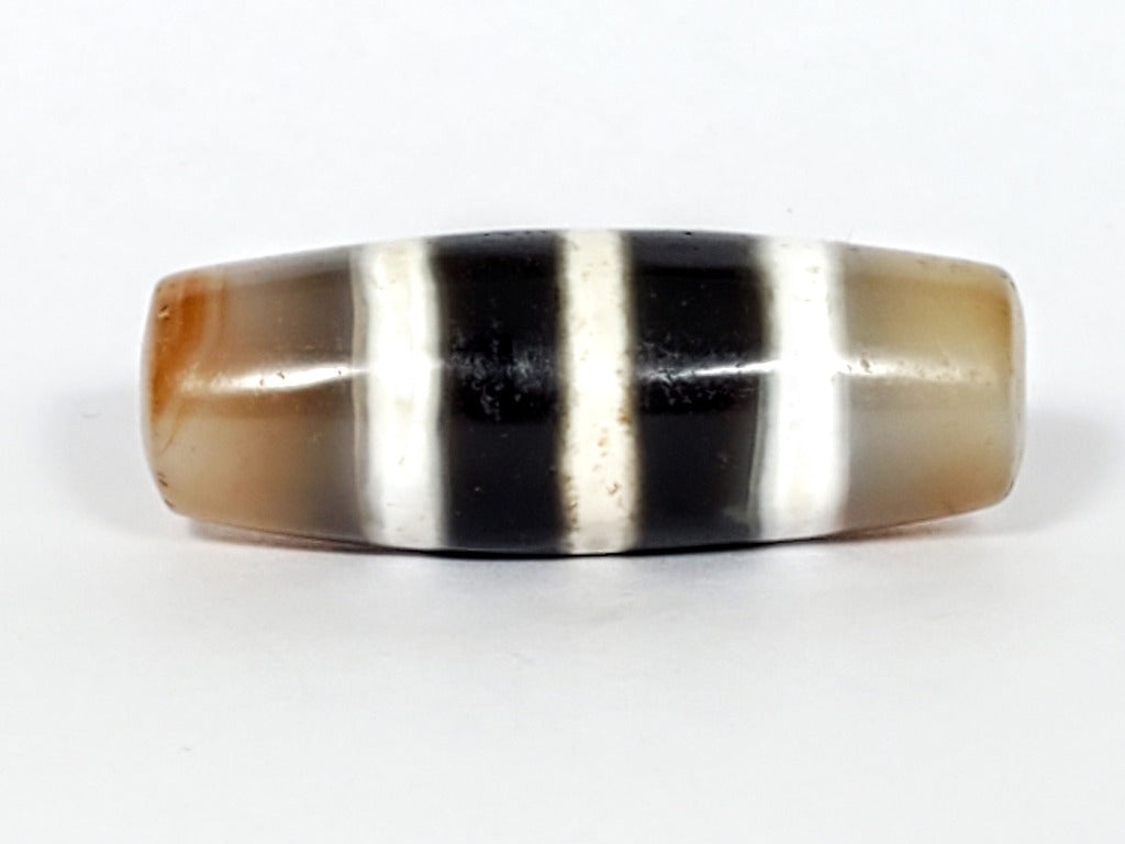 Authentic vintage Five Stripe Chung Dzi bead showcasing its unique five stripe pattern. This ancient bead holds historical and cultural significance