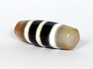 Authentic vintage Five Stripe Chung Dzi bead showcasing its unique five stripe pattern. This ancient bead holds historical and cultural significance