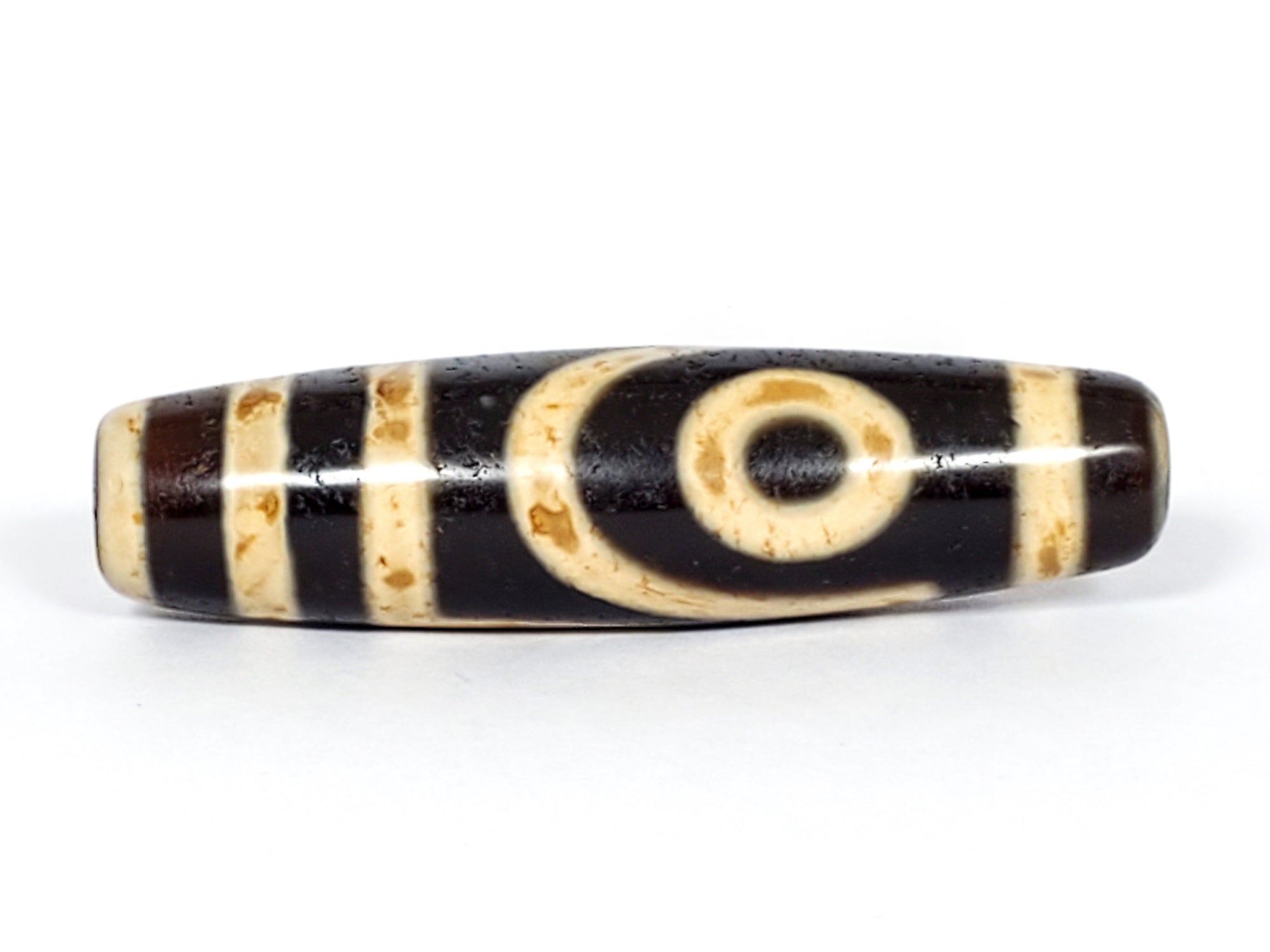 "A vintage Dzi bead featuring a captivating Two Eye Motif. This authentic artifact embodies the rich history and symbolism of ancient Dzi beads