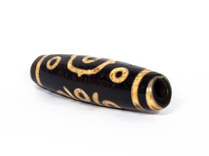 A vintage Dzi bead featuring a stunning Fourteen Eye motif with a large keyhole drilling. This rare and intricate artifact carries deep spiritual symbolism and represents auspiciousness and protection