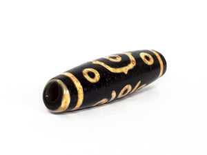 A vintage Dzi bead featuring a stunning Fourteen Eye motif with a large keyhole drilling. This rare and intricate artifact carries deep spiritual symbolism and represents auspiciousness and protection