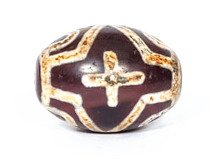 A vintage Dzi bead featuring a round shape adorned with a captivating Four Eye Lotus & Cross motif. This authentic artifact, identified as R-FoELC, showcases the intricate patterns and spiritual symbolism of ancient Dzi beads