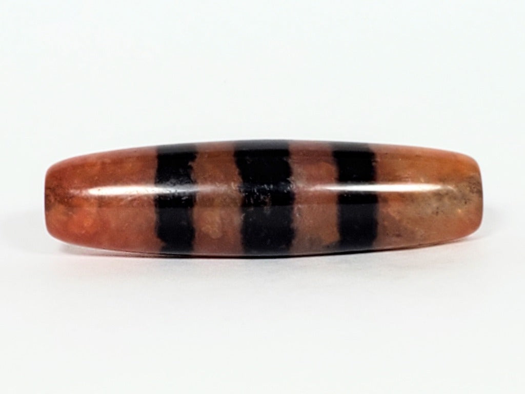 Five Stripe Chung Dzi - 措思天珠" Description: "Authentic Five Stripe Chung Dzi bead known as 措思天珠. This ancient bead showcases its unique five stripe pattern and carries cultural significance