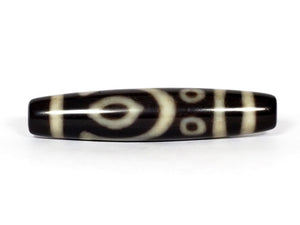 A vintage Dzi bead featuring a unique and rare variant of the Four Eye motif. This intricately carved bead showcases four eyes and carries deep spiritual significance. A collector's item with distinctive beauty