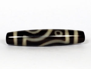 A vintage Dzi bead featuring a unique and rare variant of the Four Eye motif. This intricately carved bead showcases four eyes and carries deep spiritual significance. A collector's item with distinctive beauty