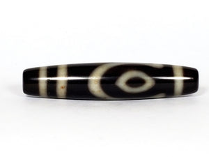 A vintage Dzi bead featuring a unique and rare variant of the Four Eye motif. This intricately carved bead showcases four eyes and carries deep spiritual significance. A collector's item with distinctive beauty