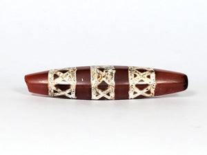 Genuine ancient Dzi bead featuring an intricate criss cross motif in captivating carnelian. Its unique hexagon shape adds to its historical charm.