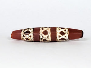 Genuine ancient Dzi bead featuring an intricate criss cross motif in captivating carnelian. Its unique hexagon shape adds to its historical charm.